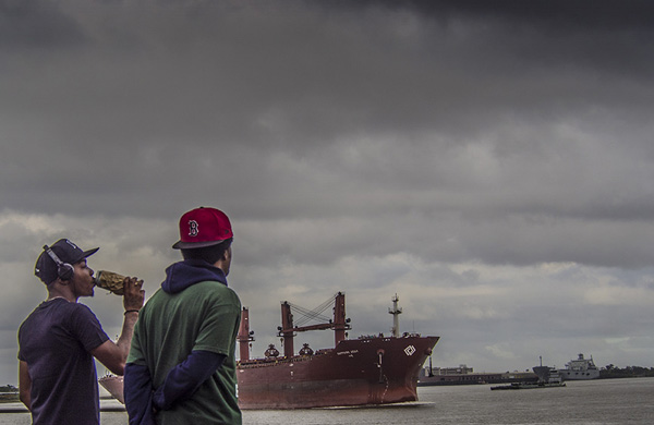 man drinking a beer on a cloudy day